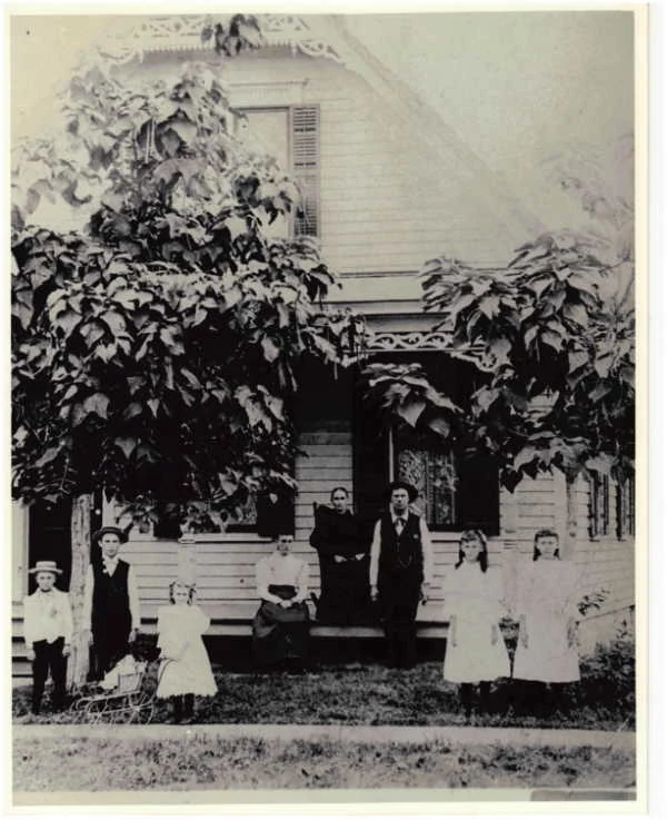 Family portrait, 5 adults and a dog, 106 North St., East Dundee, dated 1897