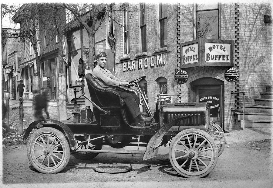 Hotel Buffet and Bar Room storefront, with a man in an early motor car