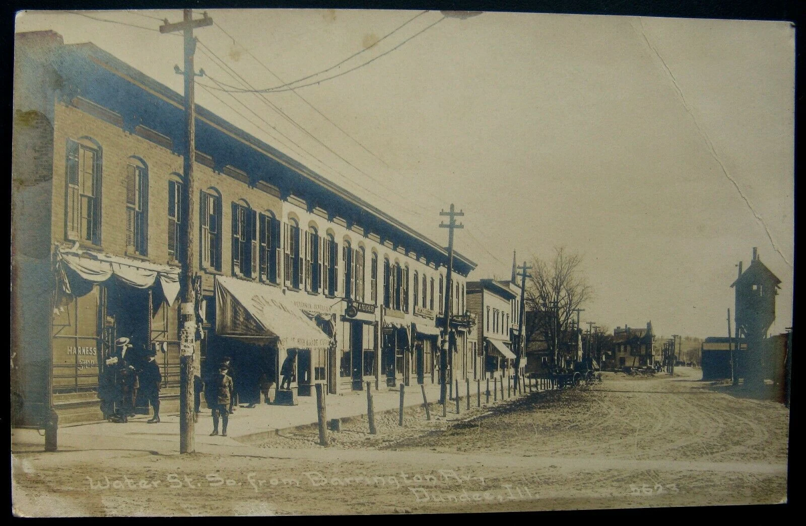 Water St. So. from Barrington Av, Dundee, Ill. — postcard with harness shop and cigar shop storefronts